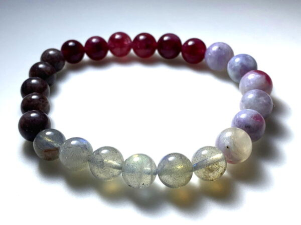 A bracelet of Plum Blossom Tourmaline, Strawberry and Brown Tourmaline, and Moonstone.