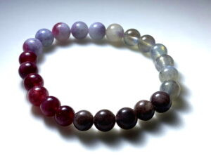 A bracelet of Plum Blossom Tourmaline, Strawberry and Brown Tourmaline, and Moonstone.