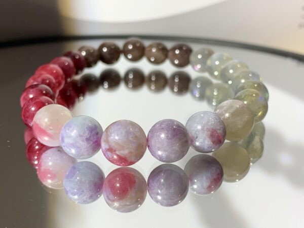 A bracelet of Plum Blossom Tourmaline, Strawberry and Brown Tourmaline, and Moonstone.